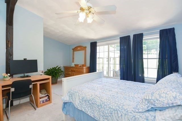 127 Haverhill Road Amesbury, MA 01913 - Photo 21 of 42 a bedroom with a bed window and a computer on a table