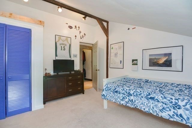 127 Haverhill Road Amesbury, MA 01913 - Photo 23 of 42 a bedroom with a bed and a flat screen tv