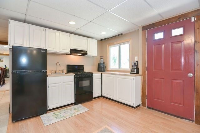 127 Haverhill Road Amesbury, MA 01913 - Photo 33 of 42 a kitchen with a refrigerator and a stove top oven