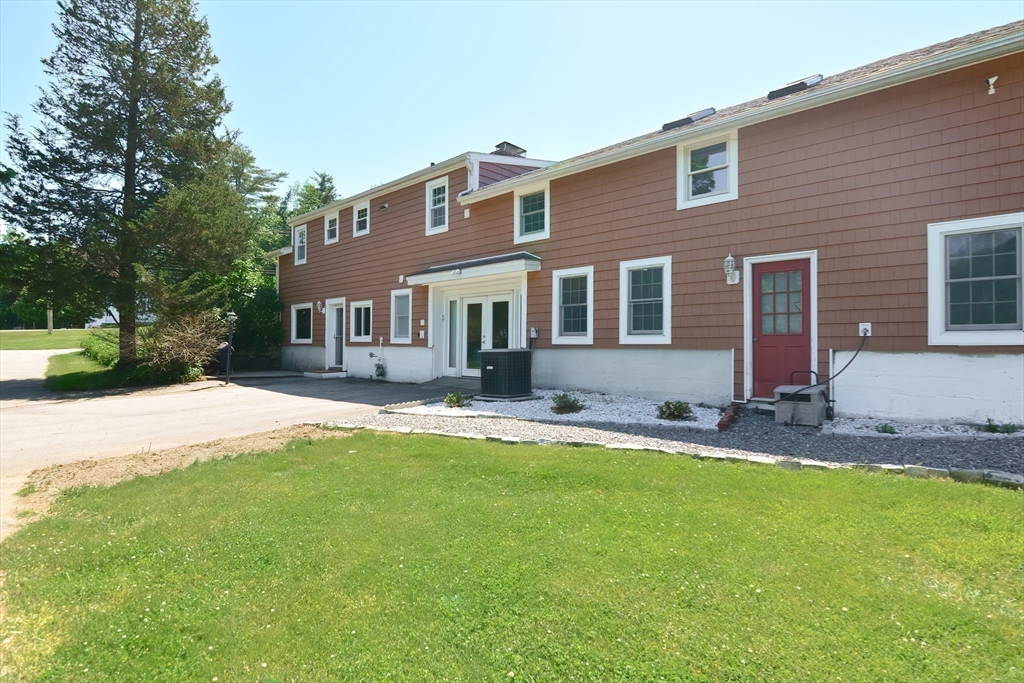 127 Haverhill Road Amesbury, MA 01913 - Photo 41 of 42 a front view of a house with a yard and porch