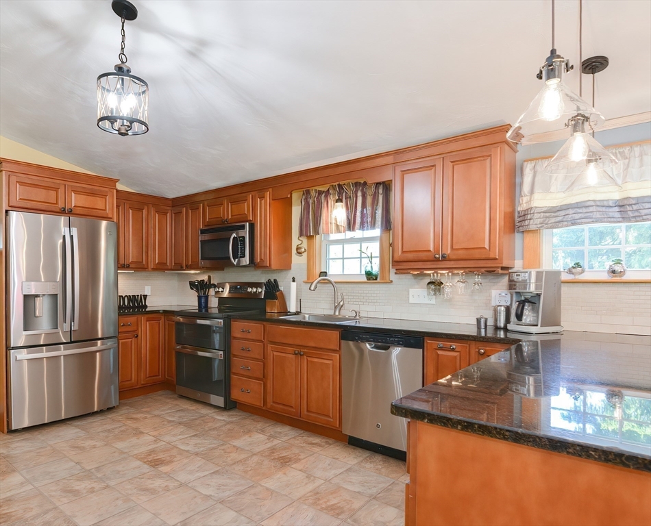 127 Haverhill Road Amesbury, MA 01913 - Photo 6 of 42 a kitchen with stainless steel appliances granite countertop a sink stove and refrigerator