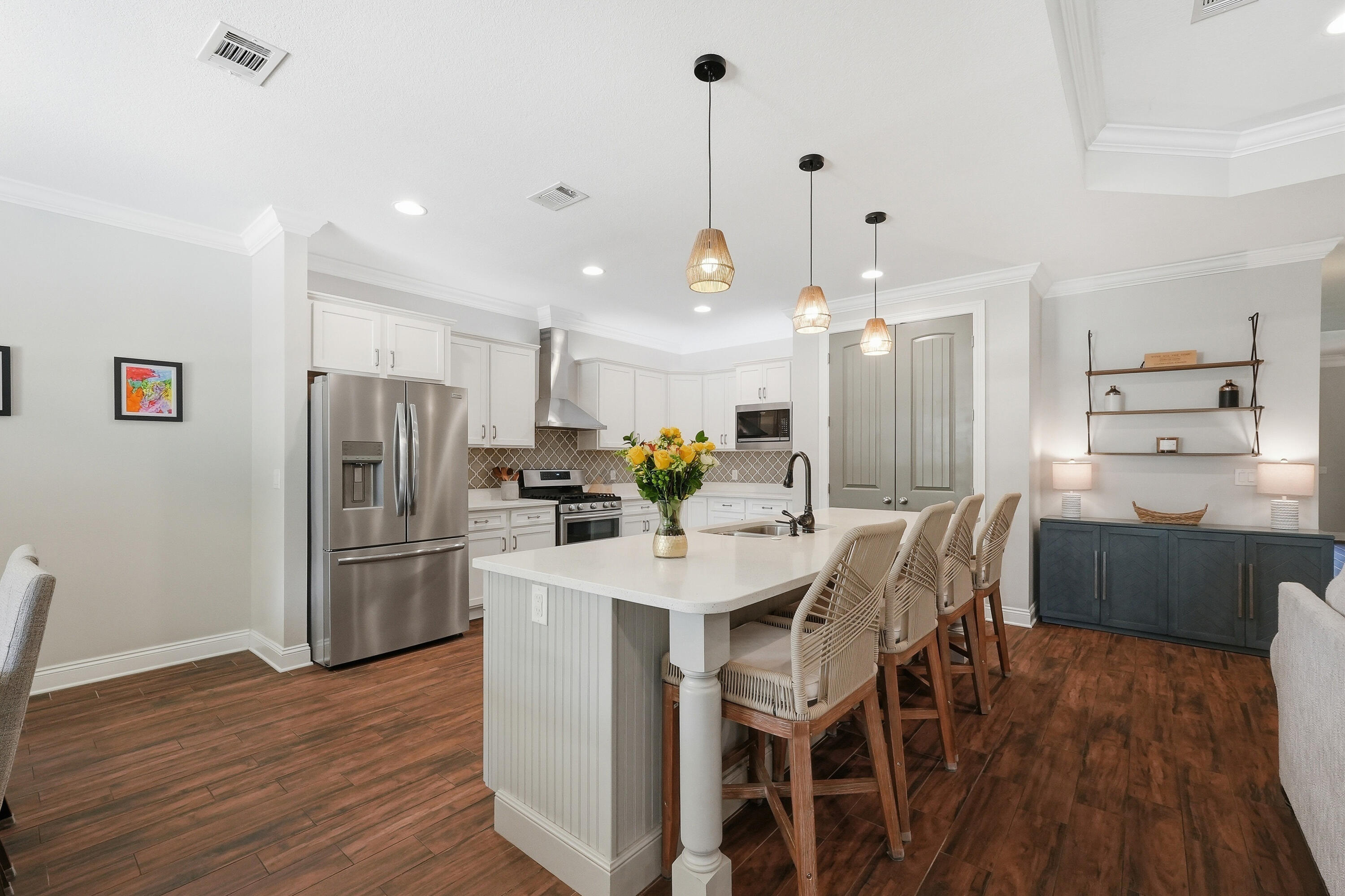 38 Marlborough Road Shalimar, FL 32579 - Photo 13 of 68 a kitchen with stainless steel appliances kitchen island granite countertop a dining table chairs and wooden floor