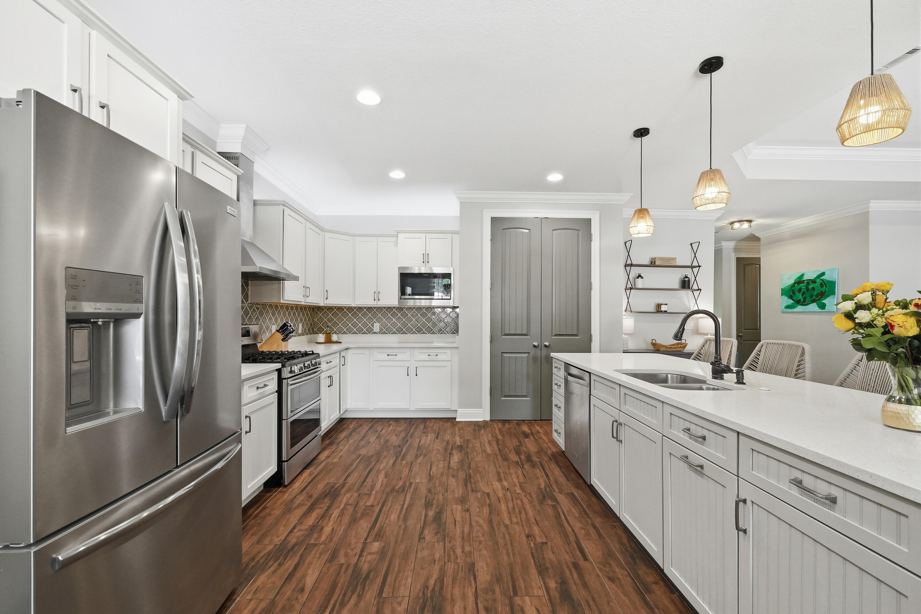 38 Marlborough Road Shalimar, FL 32579 - Photo 14 of 68 a kitchen with white cabinets and stainless steel appliances