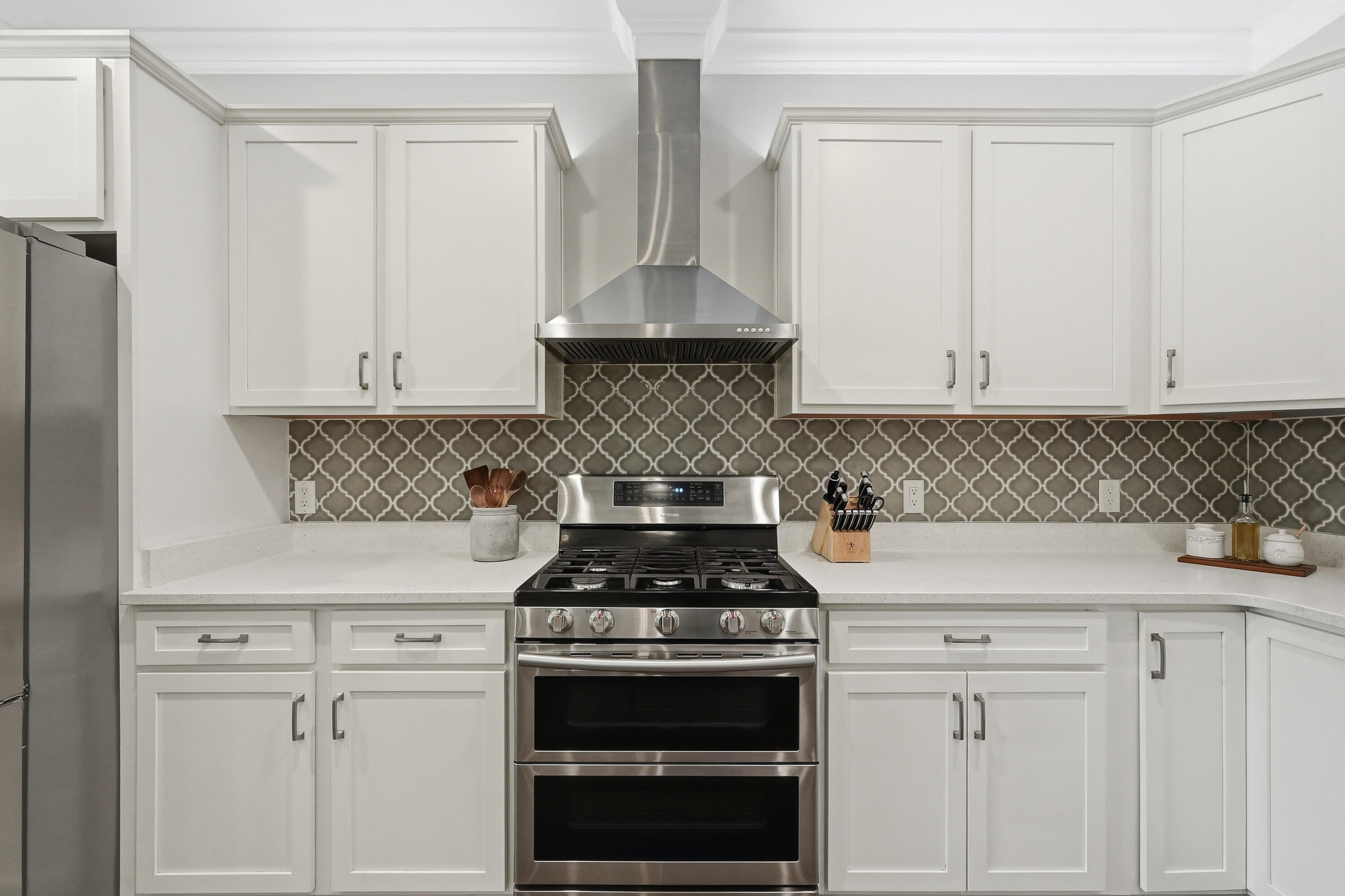 38 Marlborough Road Shalimar, FL 32579 - Photo 18 of 68 a kitchen with white cabinets and black appliances