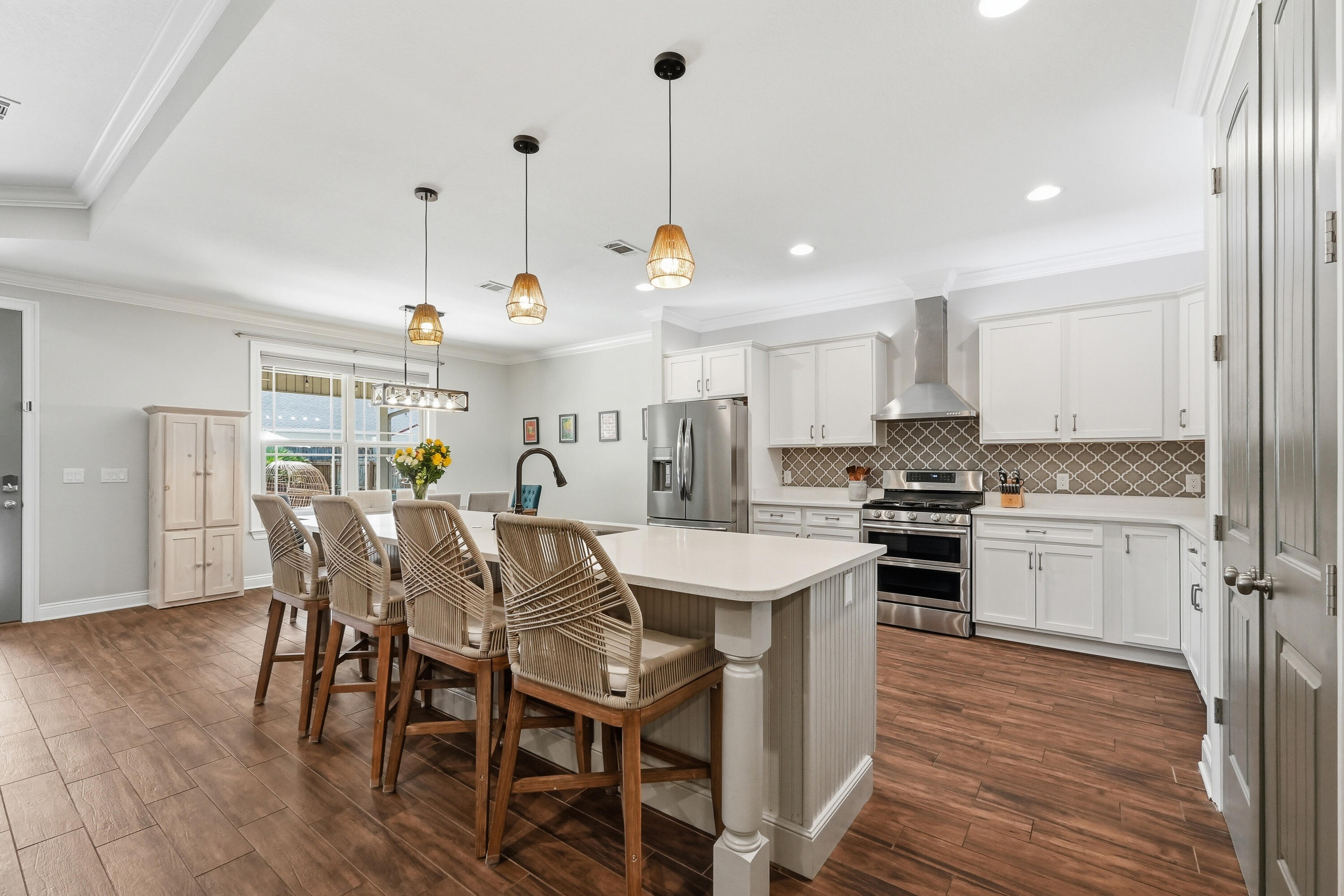 38 Marlborough Road Shalimar, FL 32579 - Photo 20 of 68 a kitchen with stainless steel appliances kitchen island granite countertop a dining table chairs and sink