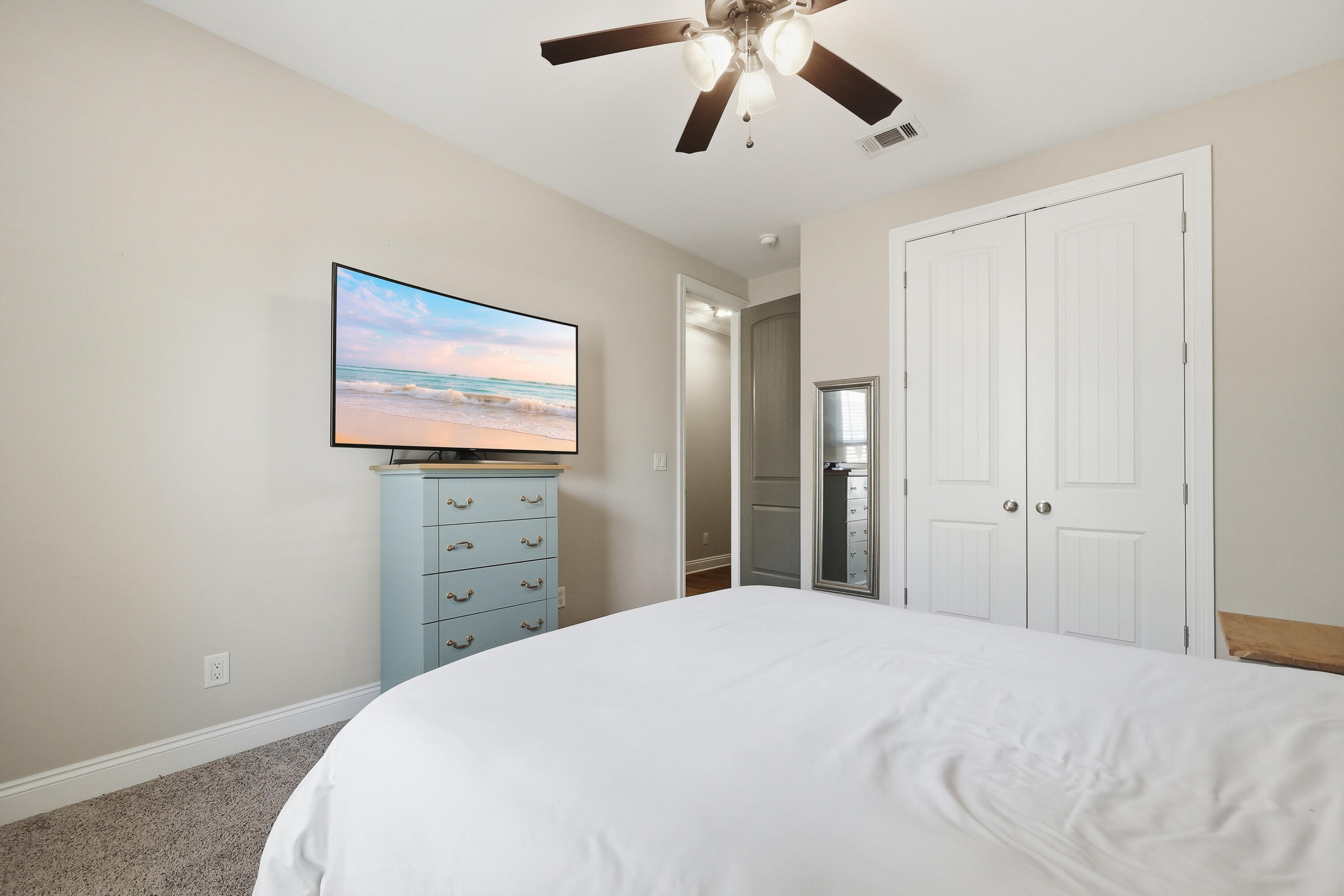 38 Marlborough Road Shalimar, FL 32579 - Photo 53 of 68 a bedroom with a bed and a chandelier