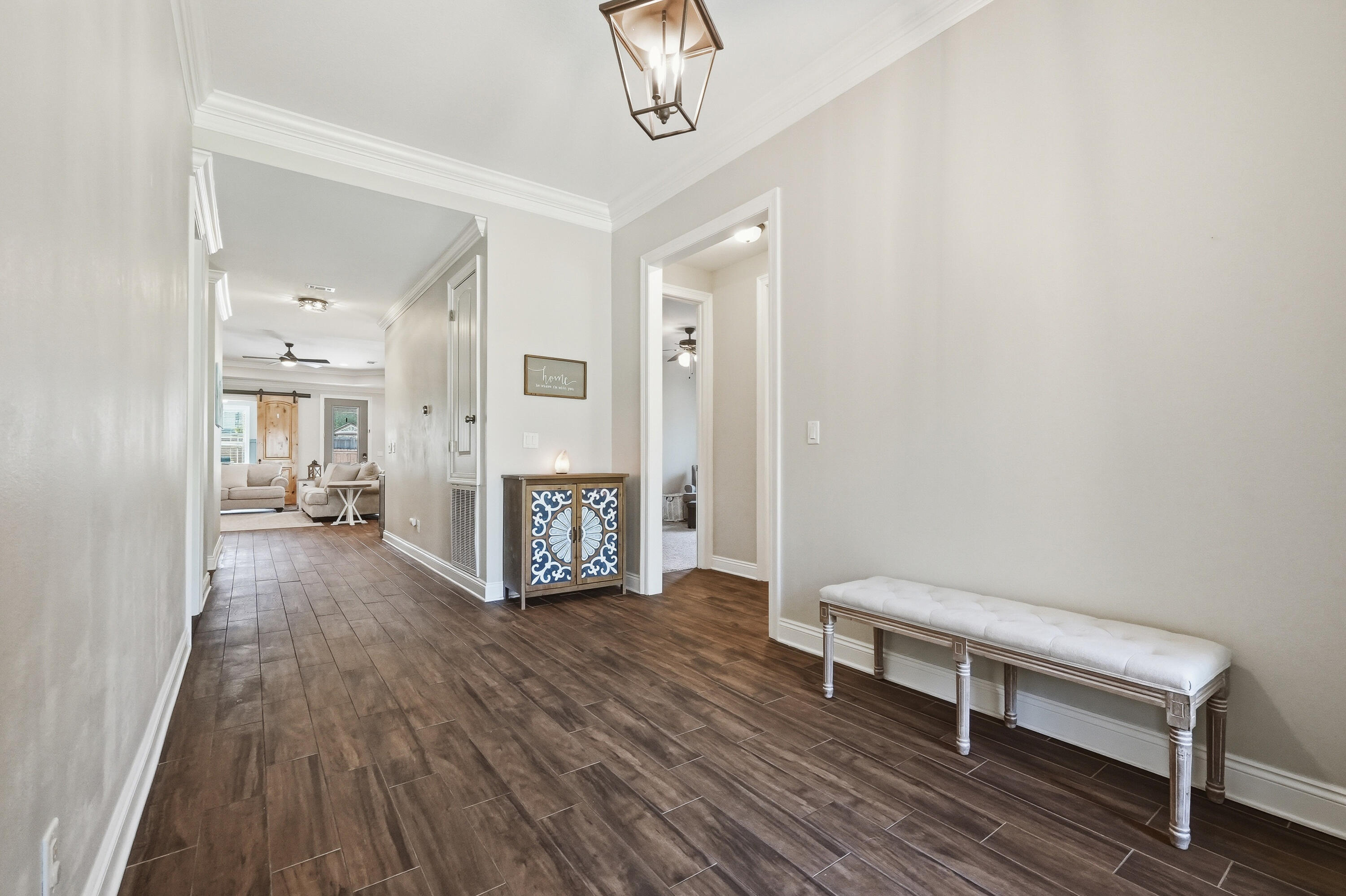 38 Marlborough Road Shalimar, FL 32579 - Photo 9 of 68 a view of a hallway with wooden floor and furniture