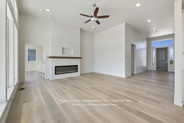 a view of an empty room with a fireplace and a window