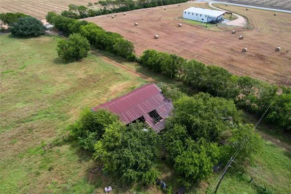 an aerial view of a house with a yard