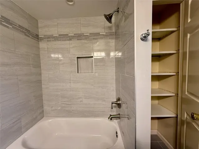 a bathroom with a shower and a bath tub
