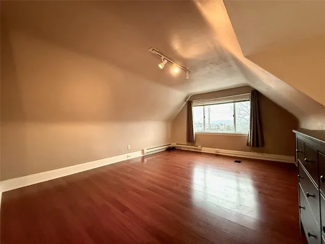 a view of a room with wooden floor and window