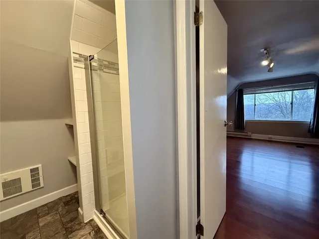 a bathroom with a glass shower door