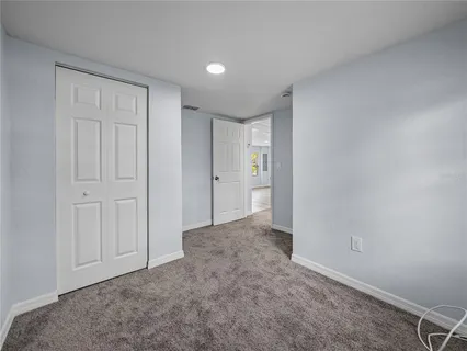 a view of an empty room and closet area