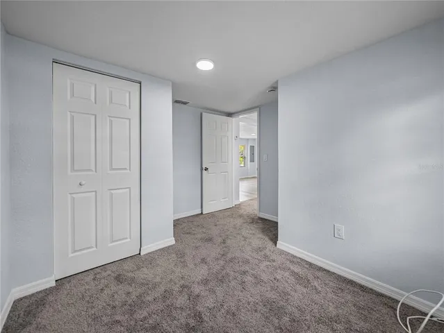 a view of an empty room and closet area