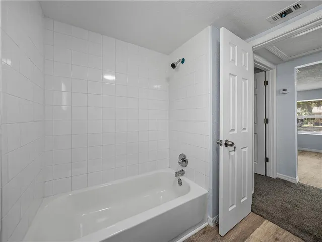 a bathroom with a bathtub and shower