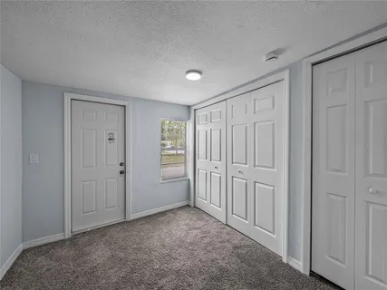 a view of an empty room and closet area