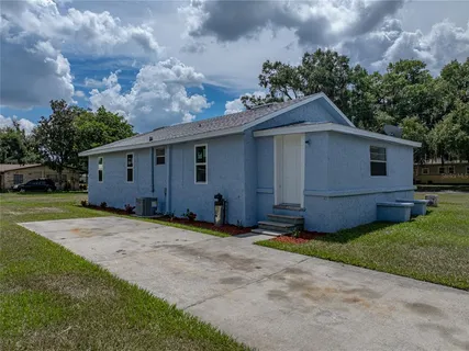 a view of a house with yard and a garden