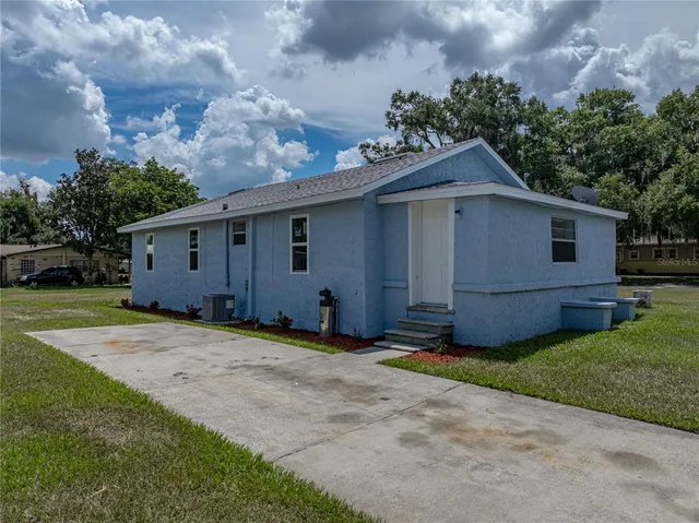 a view of a house with yard and a garden
