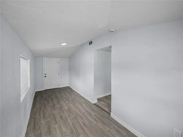 a view of a room with wooden floor