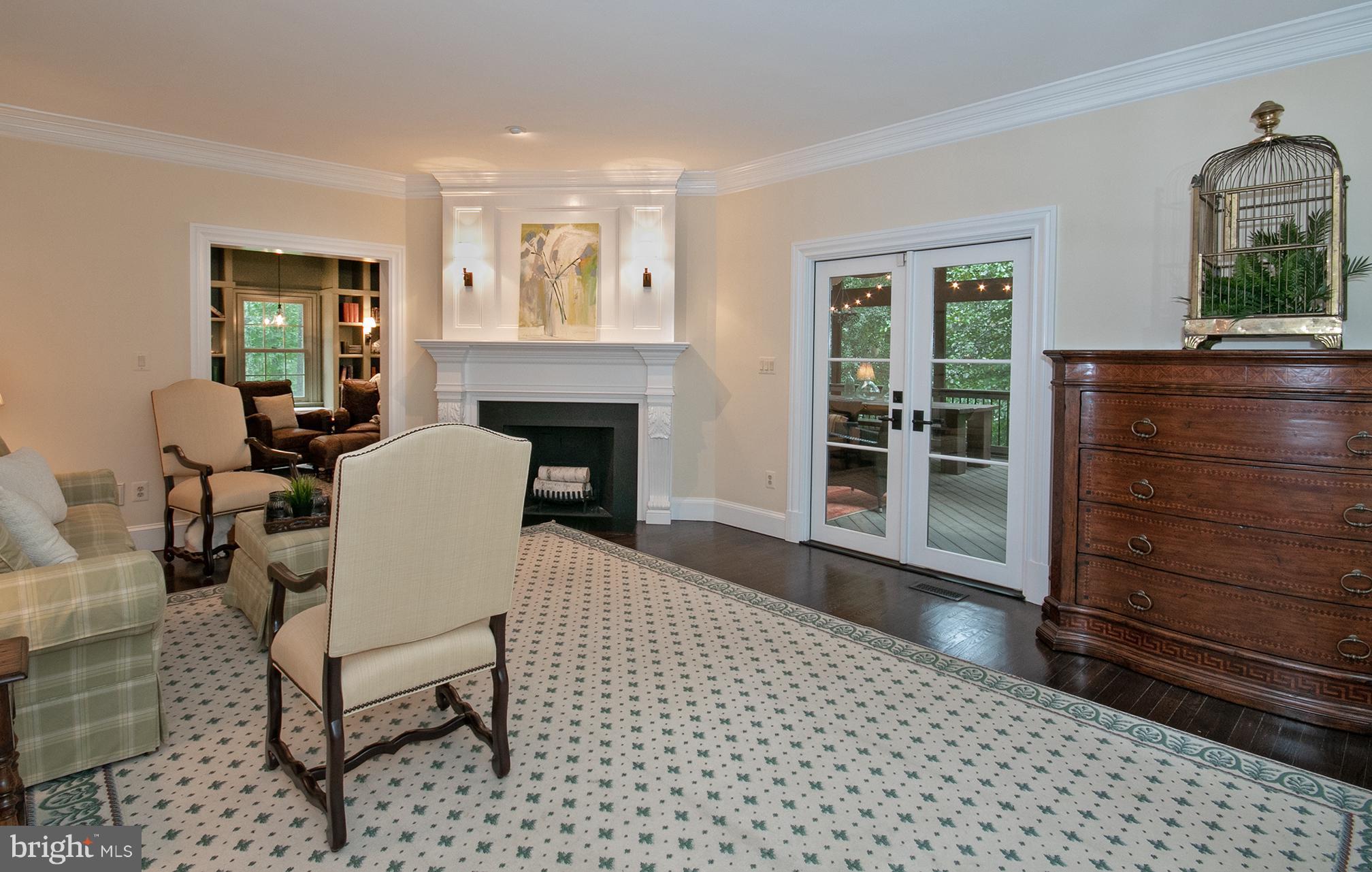 684 Springvale Road Great Falls, VA 22066 - Photo 3 of 27 a living room with furniture a fireplace and a table