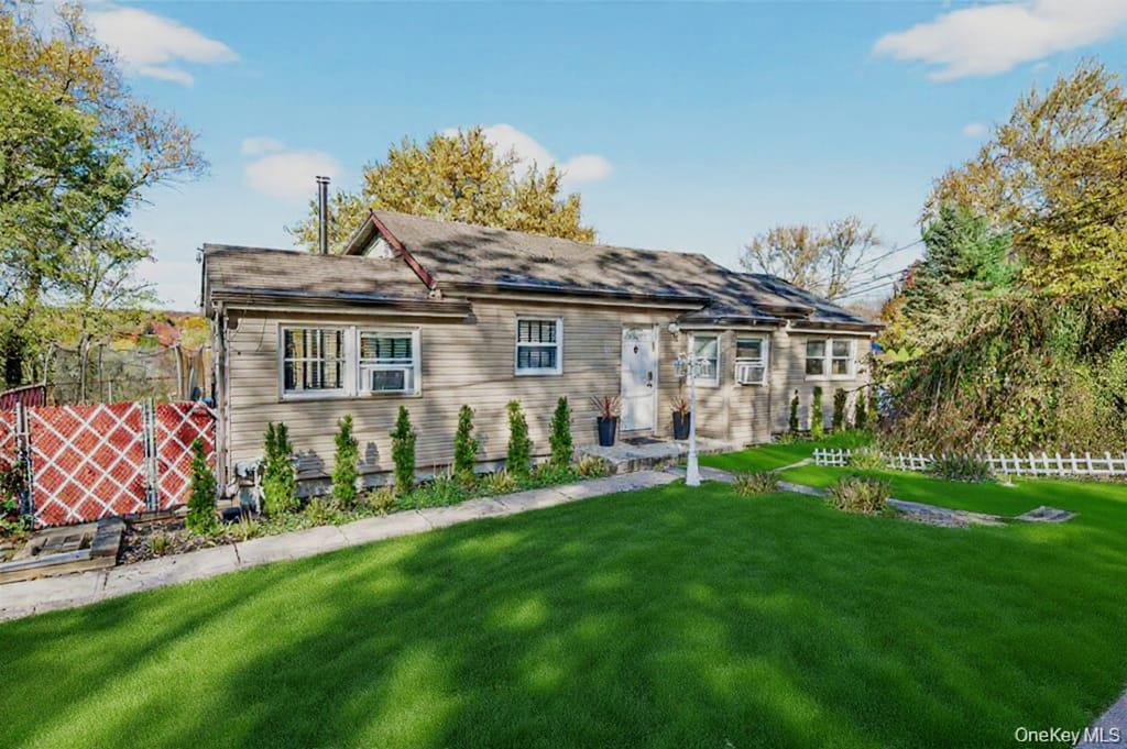 a front view of a house with a garden and plants