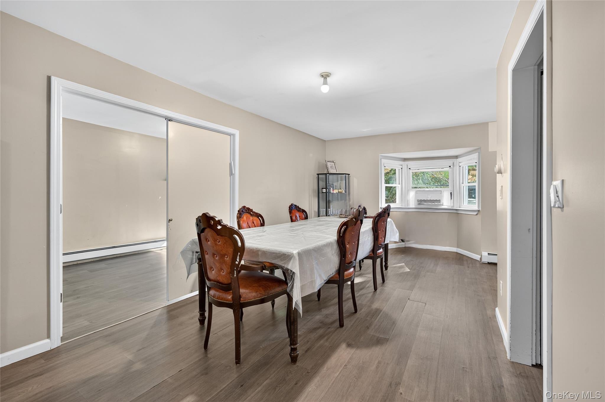 469 Hillside Road Monroe, NY 10950 - Photo 11 of 44 Dining area featuring a baseboard heating unit and wood finished floors