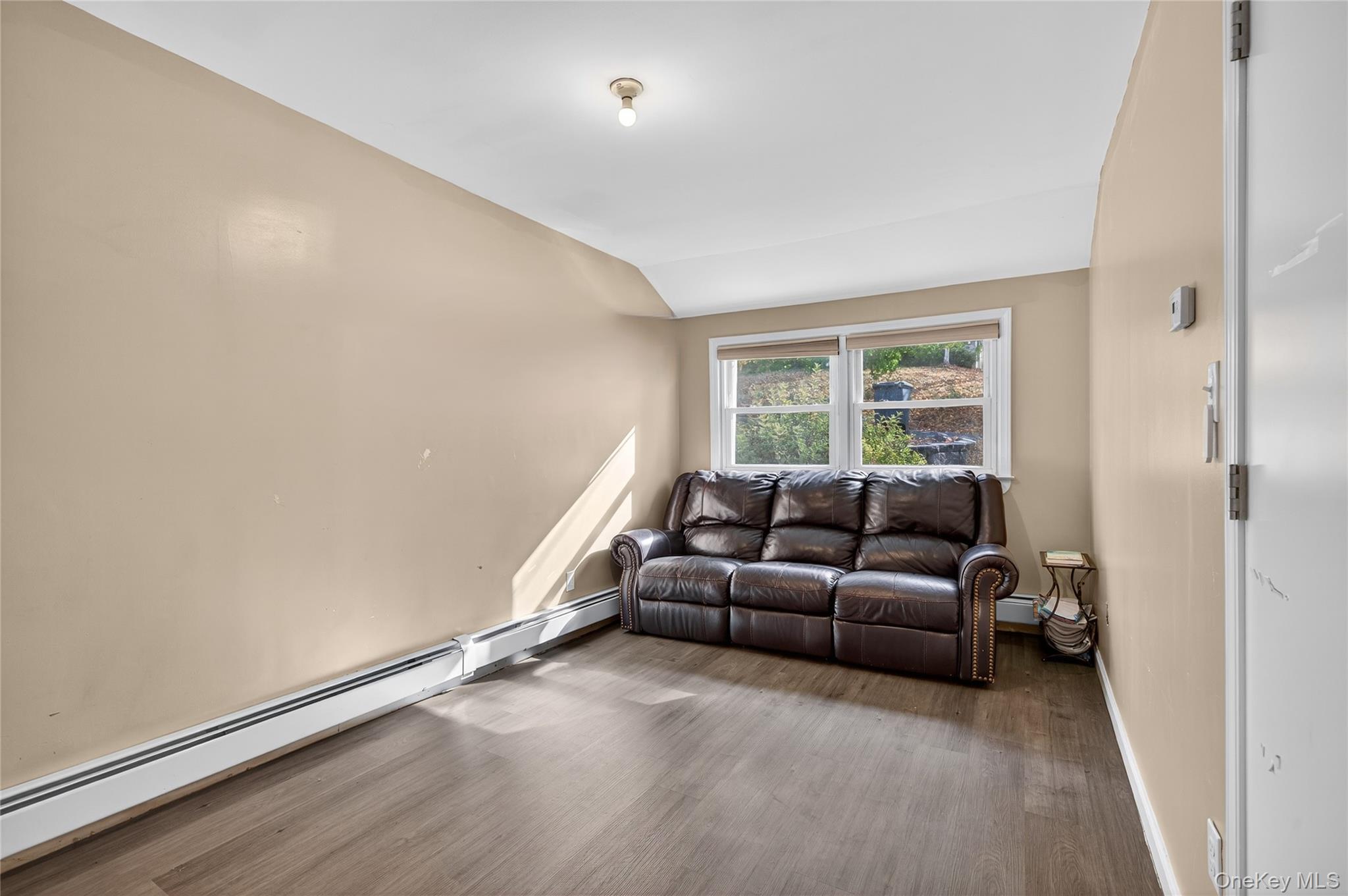 469 Hillside Road Monroe, NY 10950 - Photo 16 of 44 Living room featuring a baseboard radiator, lofted ceiling, and wood finished floors