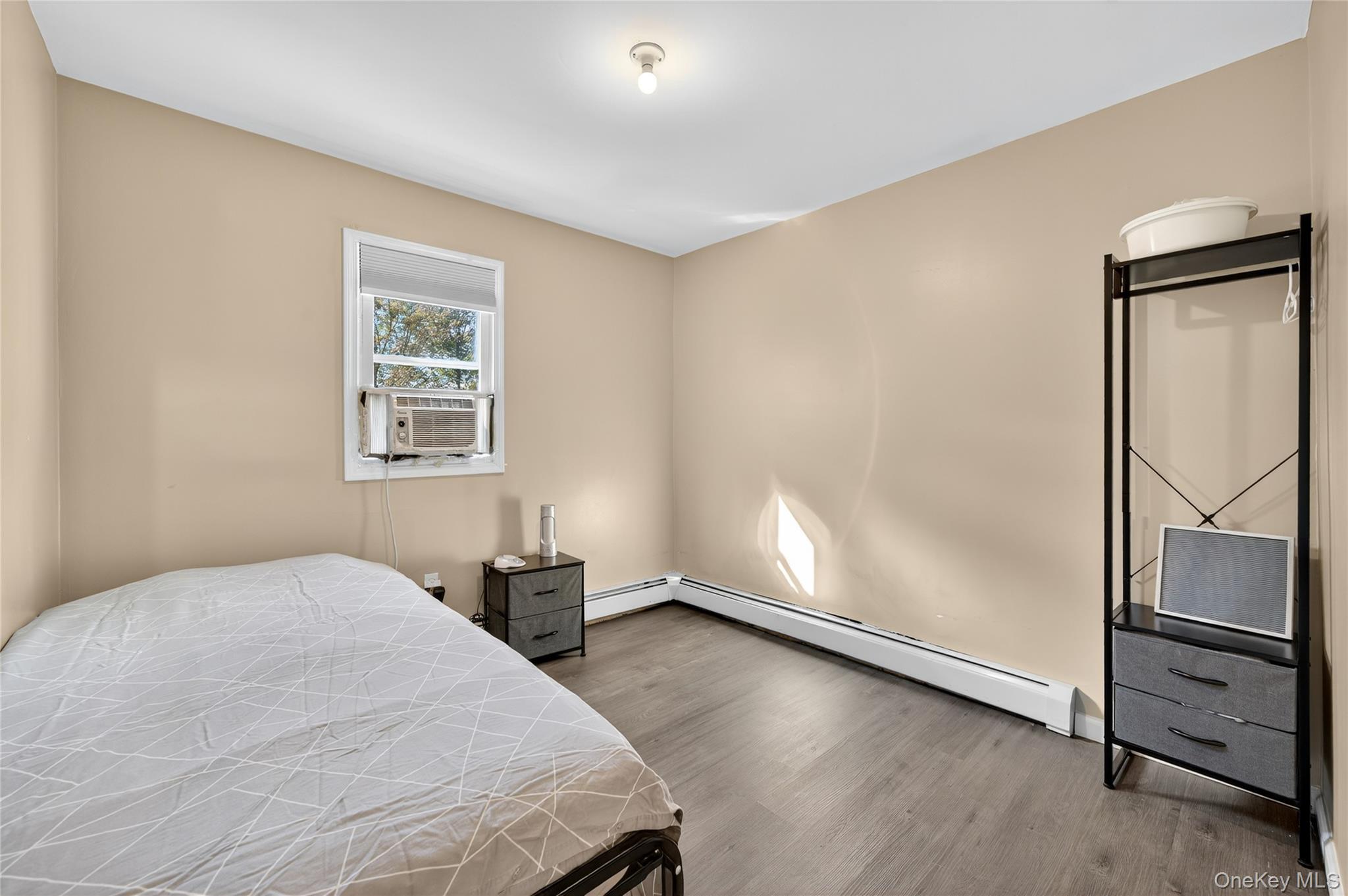 469 Hillside Road Monroe, NY 10950 - Photo 18 of 44 Bedroom with wood finished floors, cooling unit, and a baseboard radiator