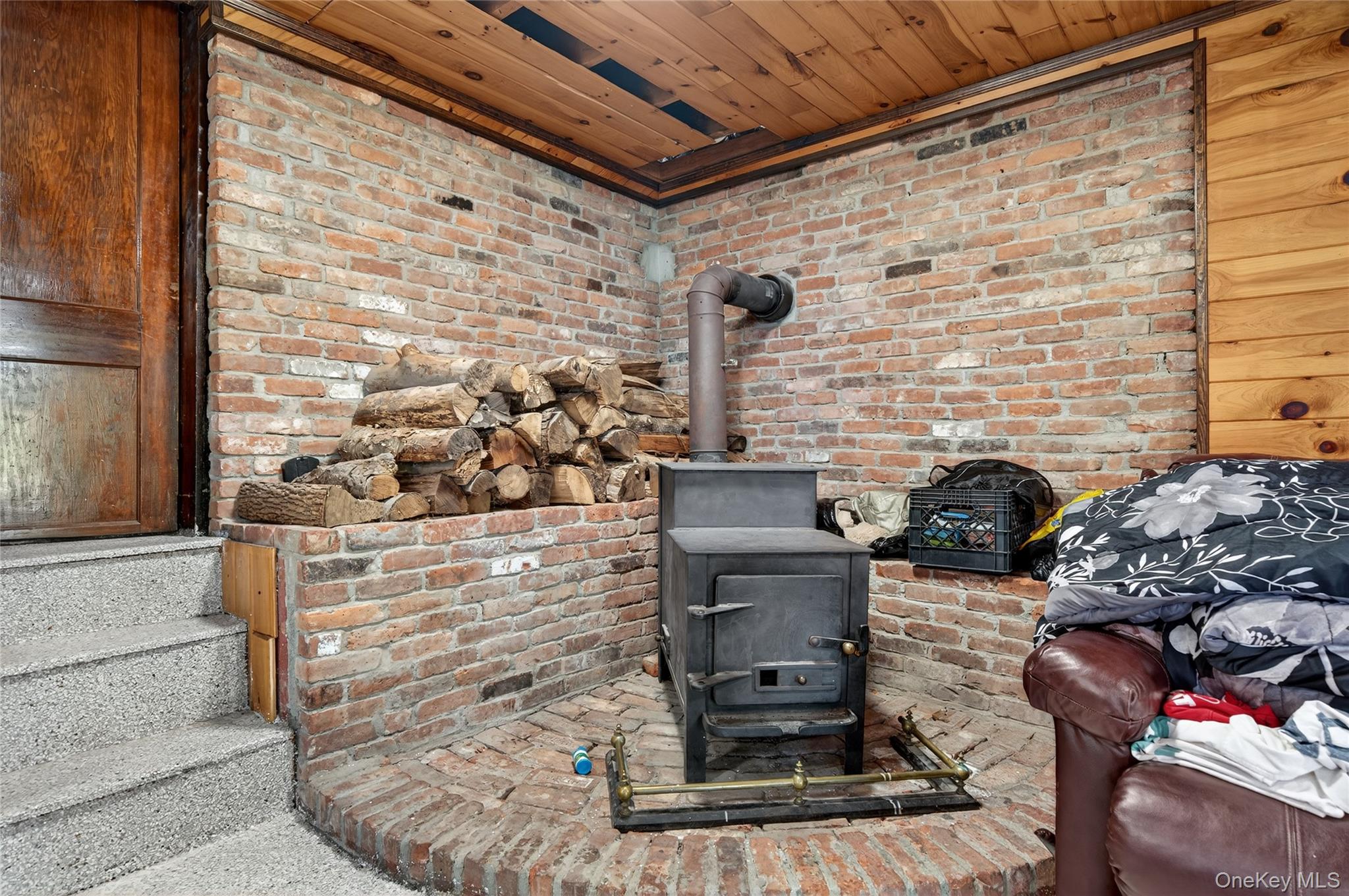 469 Hillside Road Monroe, NY 10950 - Photo 32 of 44 Detailed view of a wood stove and wood ceiling