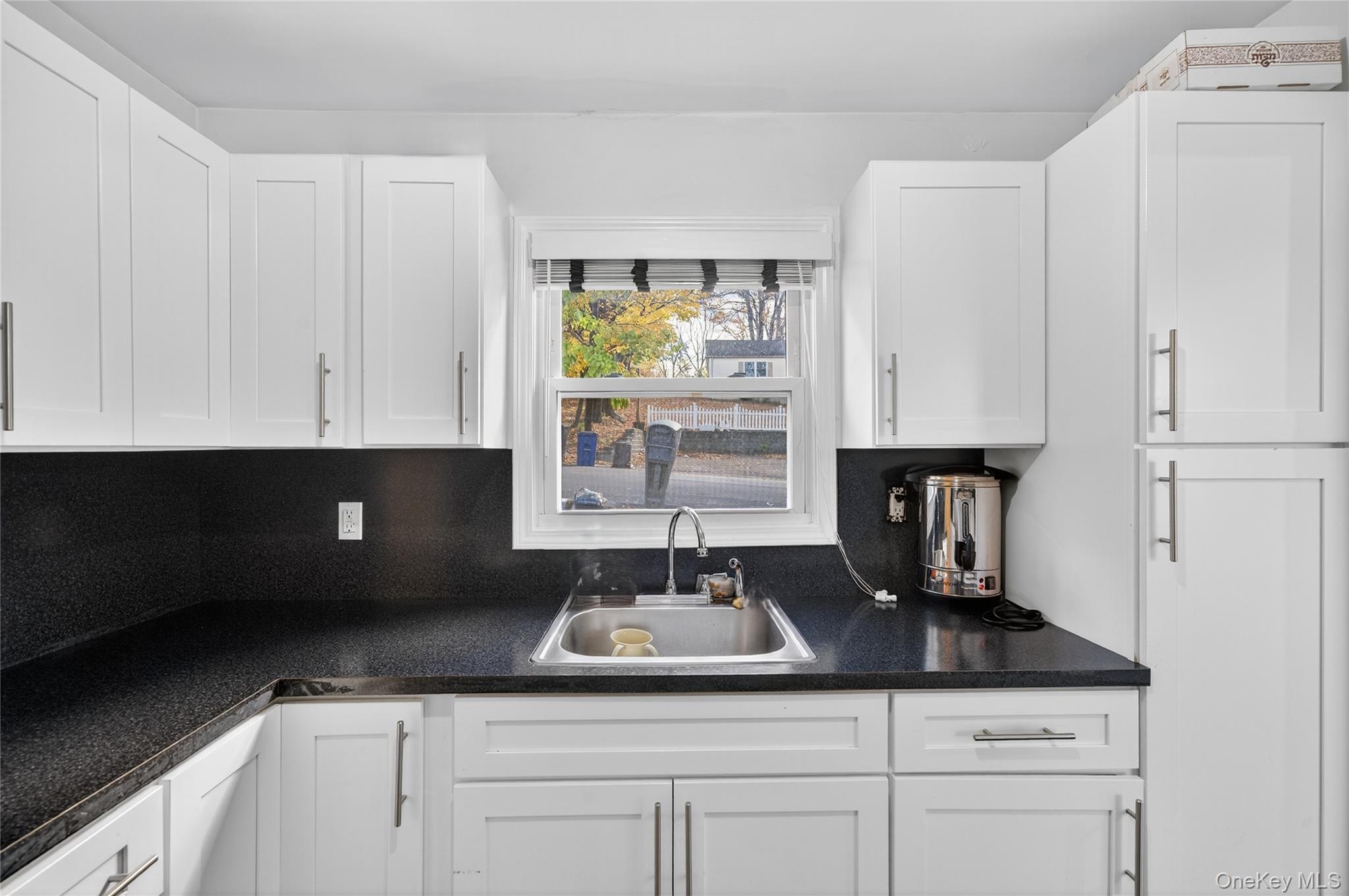 469 Hillside Road Monroe, NY 10950 - Photo 10 of 44 a kitchen with white cabinets and sink