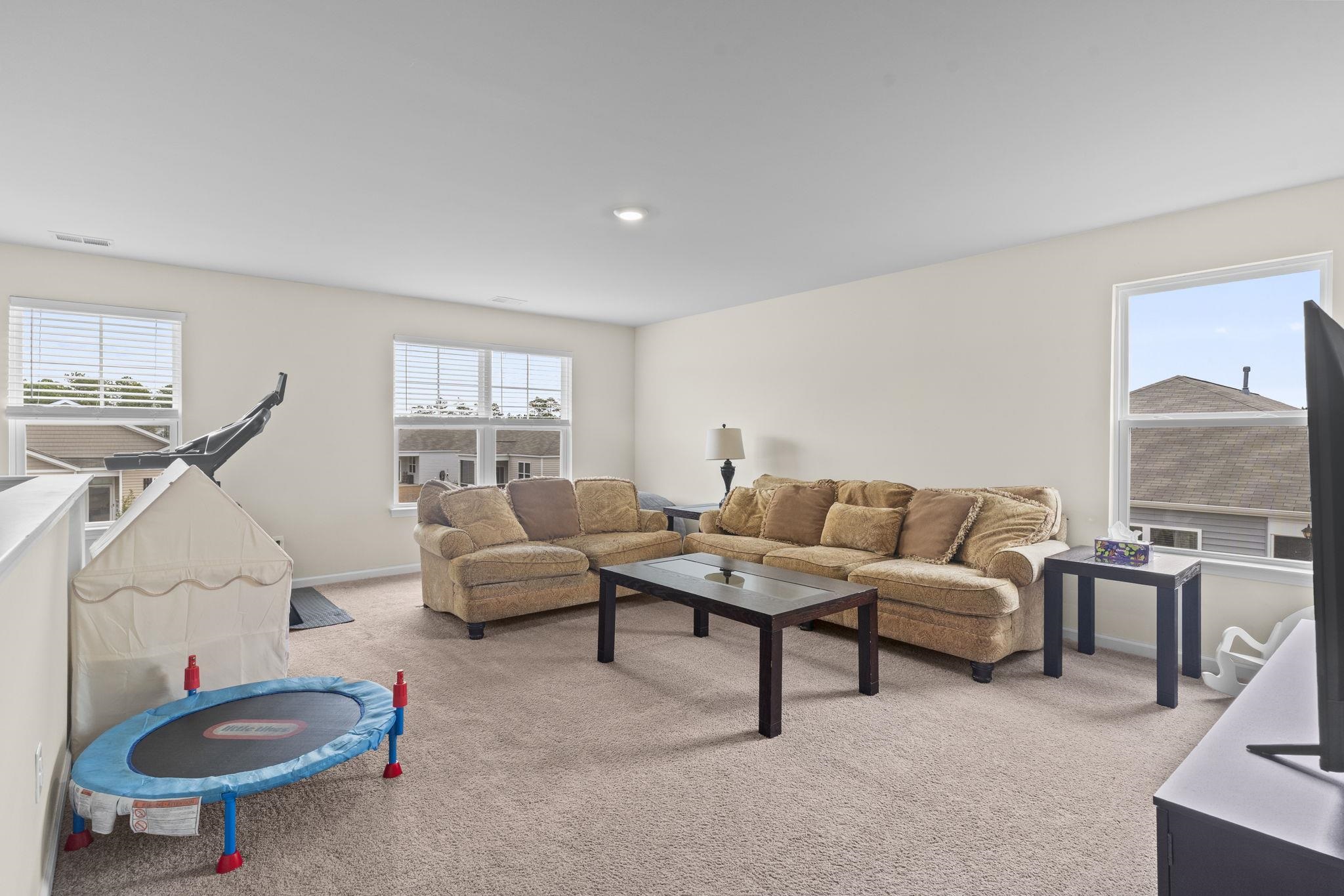 2605 Muhly Court Conway, SC 29526 - Photo 12 of 33 Living area featuring light colored carpet and baseboards