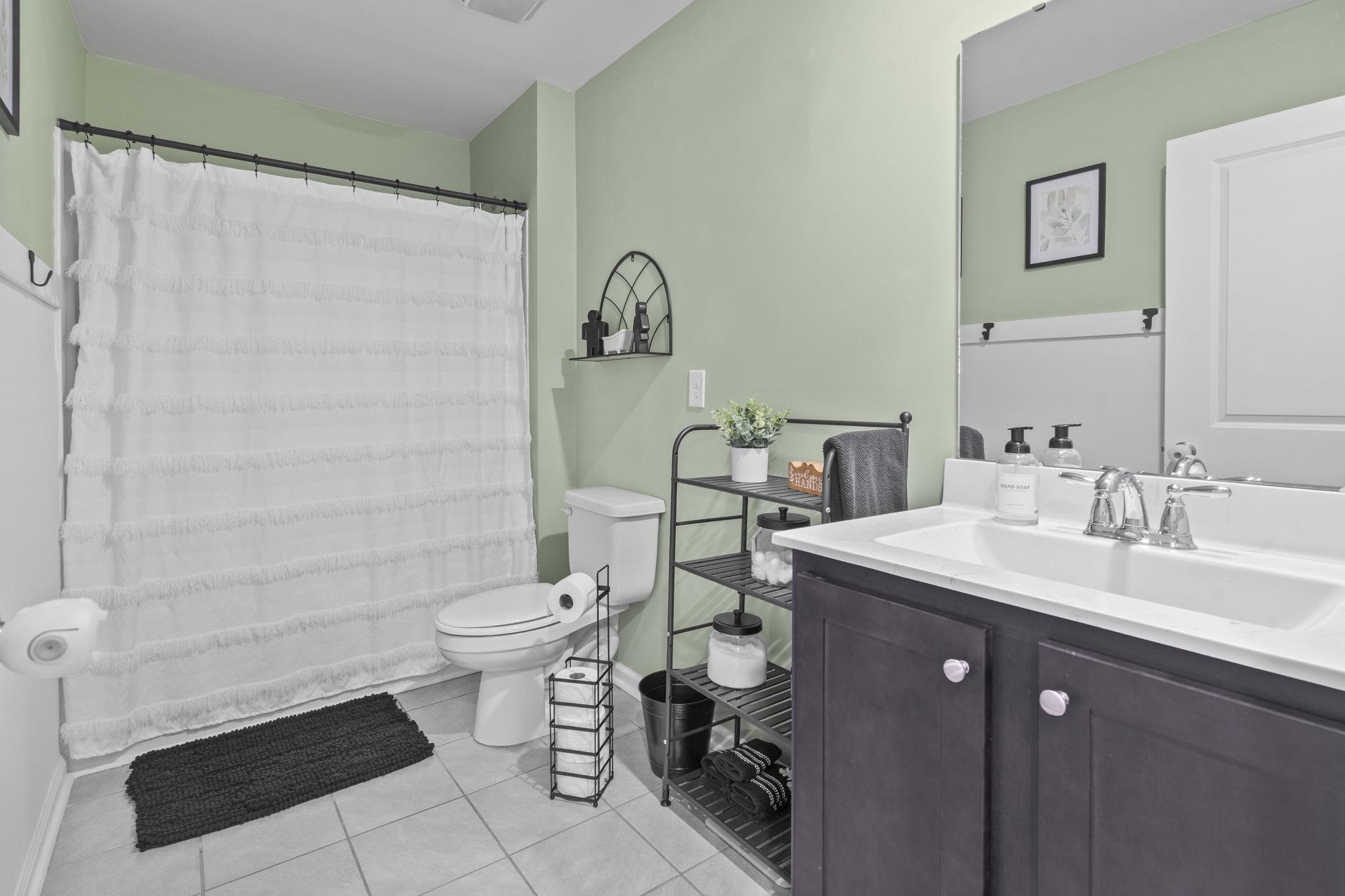 2605 Muhly Court Conway, SC 29526 - Photo 17 of 33 Bathroom with vanity, a shower with shower curtain, and light tile patterned floors