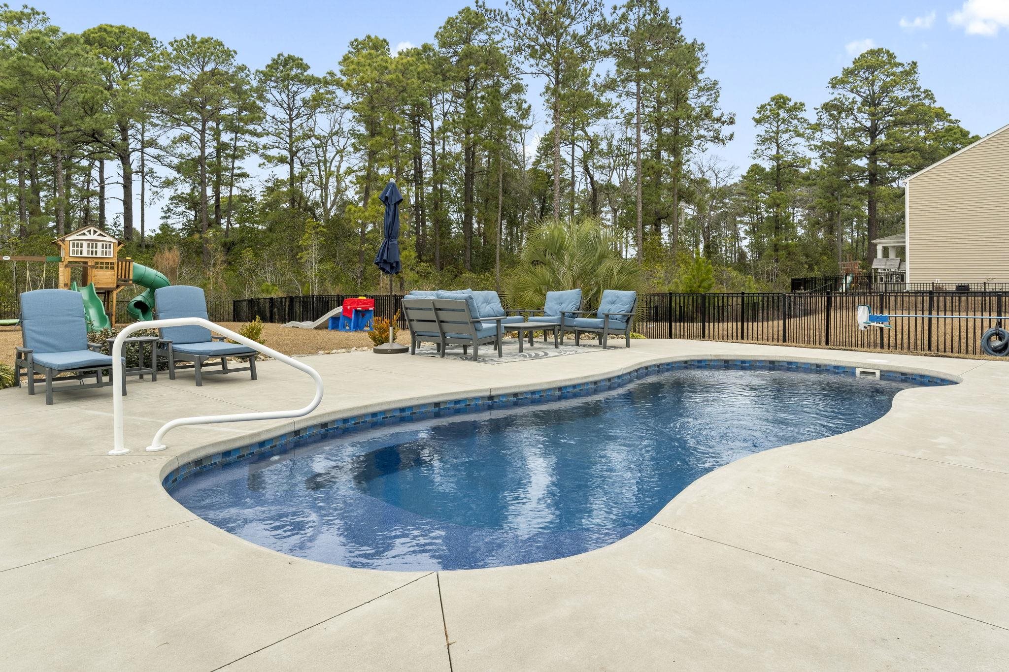 2605 Muhly Court Conway, SC 29526 - Photo 21 of 33 View of swimming pool featuring a playground, a fenced backyard, an outdoor hangout area, and a patio
