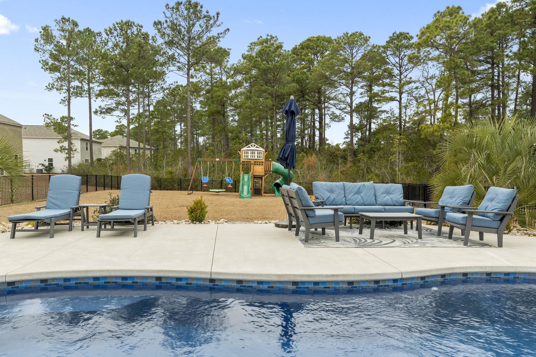 2605 Muhly Court Conway, SC 29526 - Photo 22 of 33 View of swimming pool featuring outdoor lounge area, a patio, and a playground