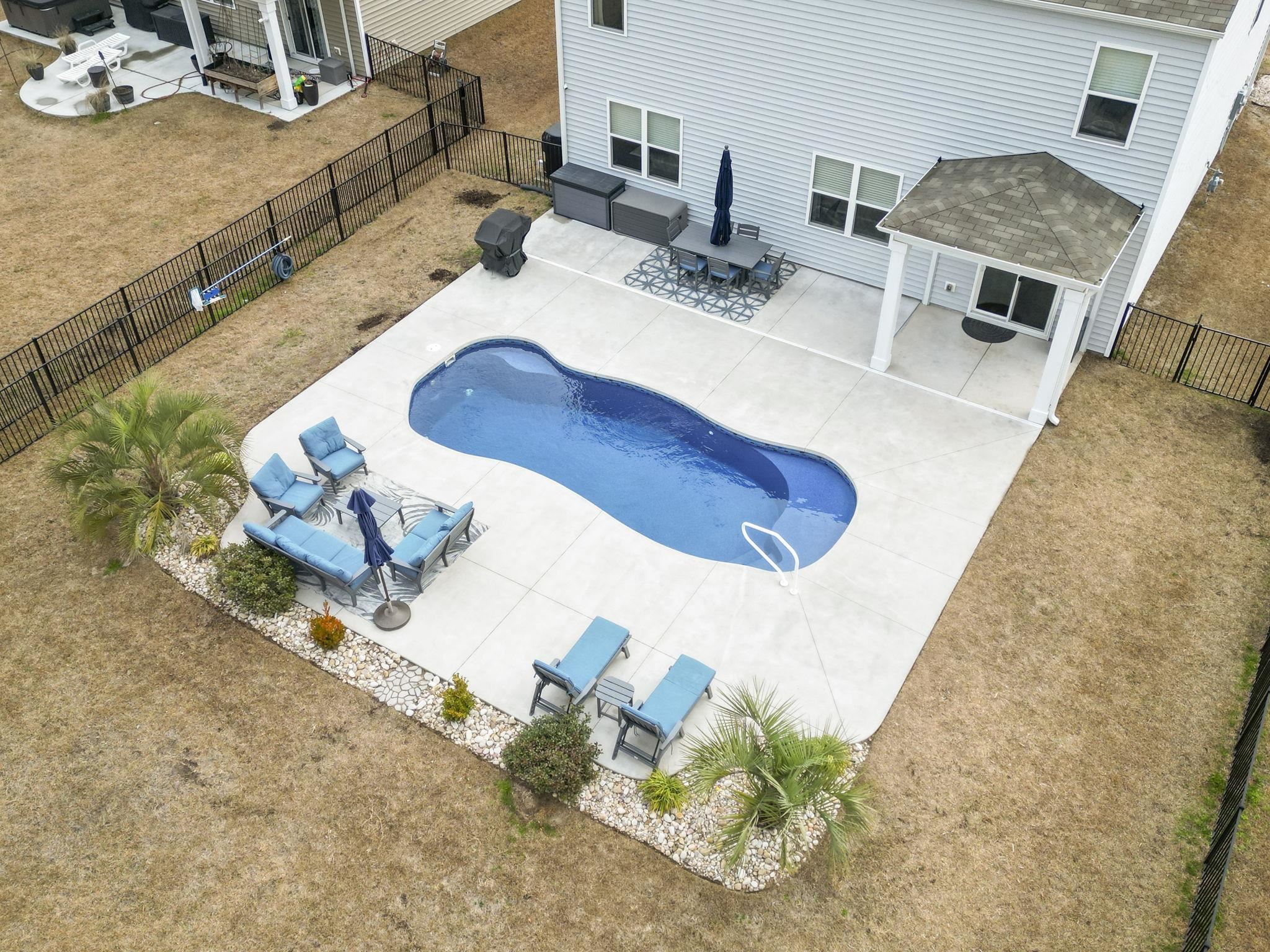 2605 Muhly Court Conway, SC 29526 - Photo 25 of 33 View of swimming pool featuring a patio, an outdoor living space, and a fenced backyard