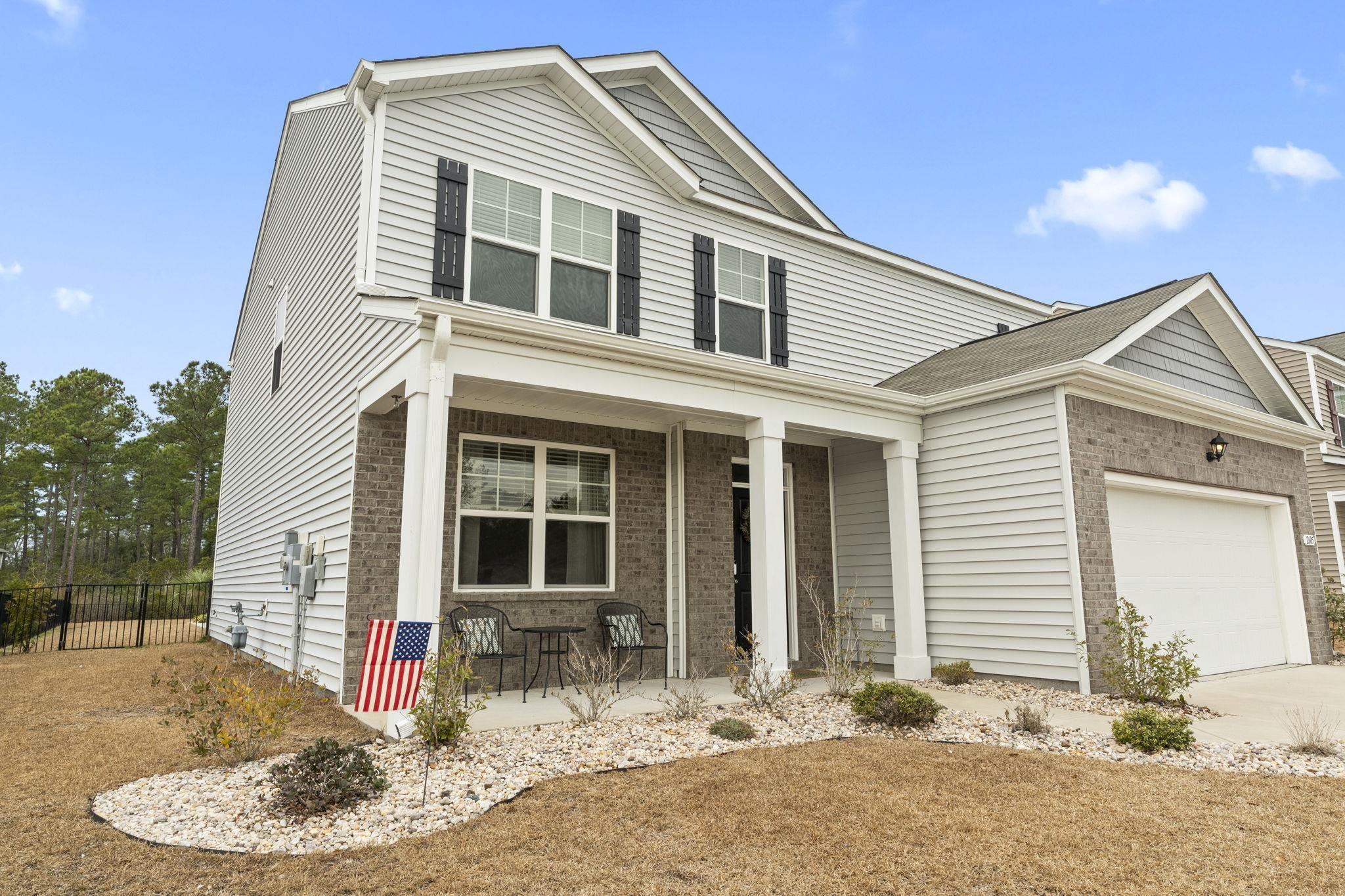 2605 Muhly Court Conway, SC 29526 - Photo 29 of 33 Traditional home featuring brick siding, covered porch, an attached garage, and driveway
