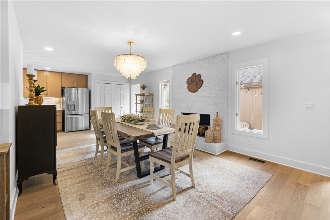 117 Riverpoint Drive Clemson, SC 29631 - Photo 7 of 47 This bright, airy dining room features a modern chandelier and a cozy fireplace, perfect for gatherings.