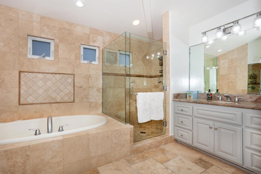527 Liverpool Drive Cardiff-by-the-Sea, CA 92007 - Photo 5 of 12 a spacious bathroom with a tub sink shower and mirror
