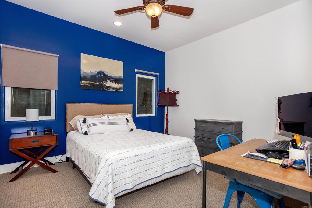 527 Liverpool Drive Cardiff-by-the-Sea, CA 92007 - Photo 8 of 12 a bedroom with a bed and a chandelier