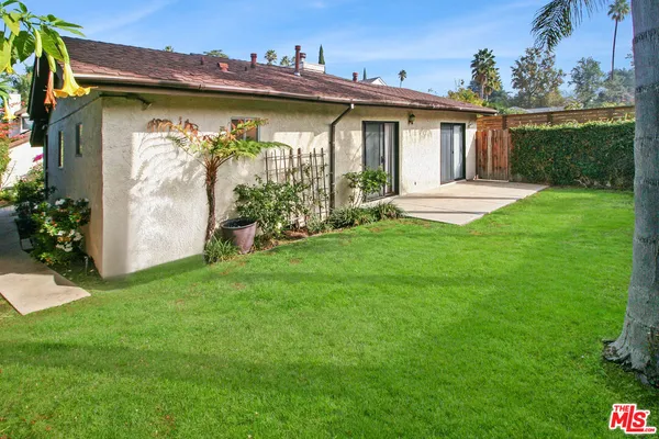 a view of a house with yard and a garden