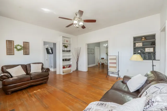 a living room with furniture and wooden floor