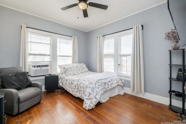 a bedroom with a bed couch and a window