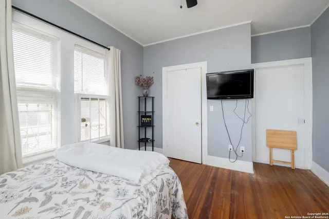 a bedroom with a bed and a flat screen tv