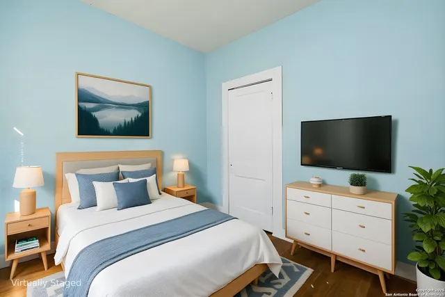 a bedroom with a bed and a flat screen tv