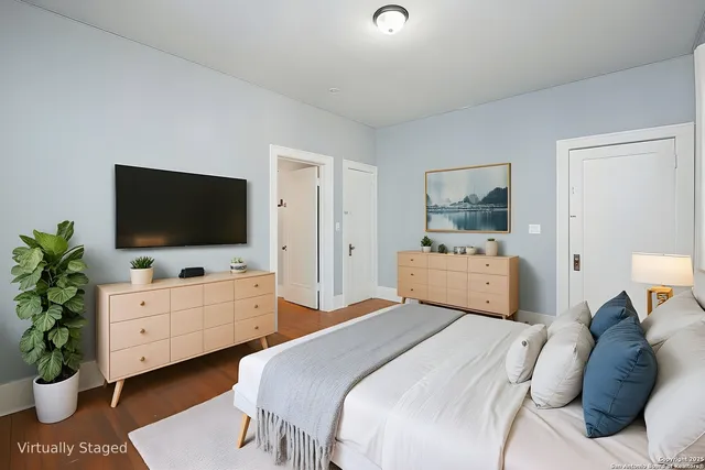 a bedroom with a bed and a flat screen tv