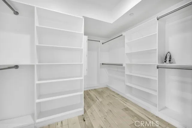 a view of walk in closet with empty racks
