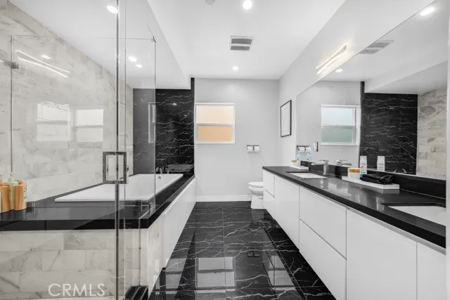 a large white kitchen with a large window