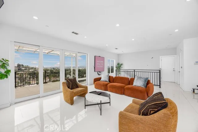 a living room with furniture and a floor to ceiling window