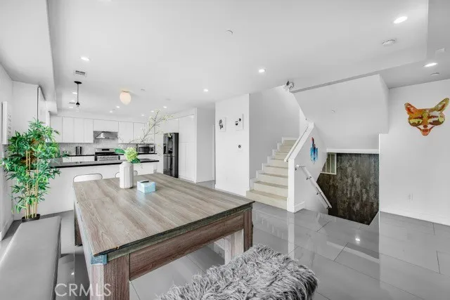 a living room with furniture and kitchen view