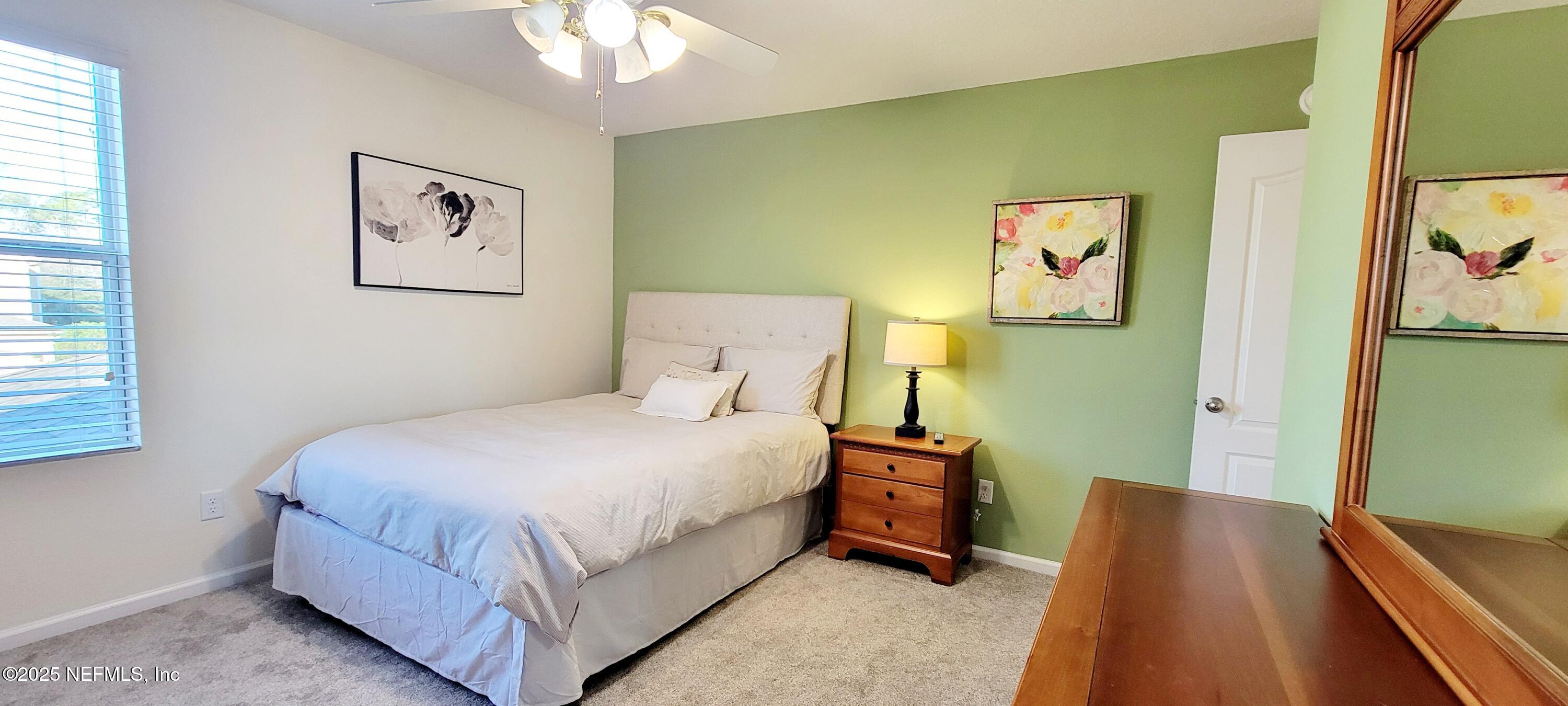 82 Whitland Way St. Augustine, FL 32086 - Photo 13 of 24 a bedroom with a bed and a flat screen tv